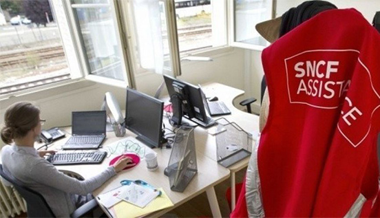 An SNCF employee teleworking from Bi Localisé. Railway tracks can be seen outside the window. (Photo provided by SNCF)